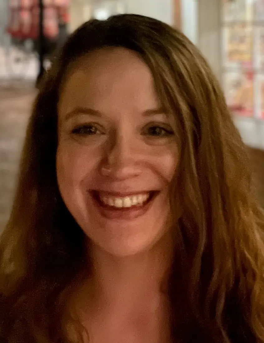 Rachel Baraks, LMHC, smiling in warm indoor lighting